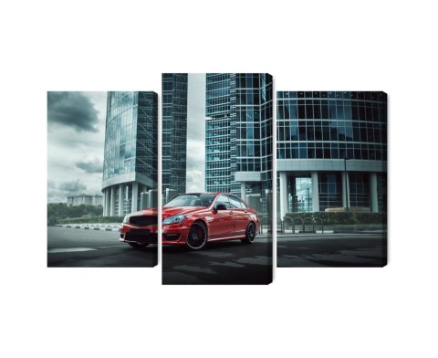 Obraz Wieloczęściowy Czerwony Samochód Na Tle Nowoczesnych Drapaczy Chmur Obraz Wieloczęściowy Czerwony Samochód Na Tle Nowoczesnych Drapaczy Chmur