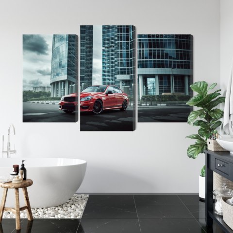 Obraz Wieloczęściowy Czerwony Samochód Na Tle Nowoczesnych Drapaczy Chmur Obraz Wieloczęściowy Czerwony Samochód Na Tle Nowoczesnych Drapaczy Chmur