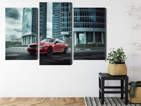 Obraz Wieloczęściowy Czerwony Samochód Na Tle Nowoczesnych Drapaczy Chmur Obraz Wieloczęściowy Czerwony Samochód Na Tle Nowoczesnych Drapaczy Chmur