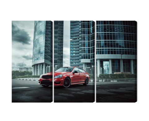 Obraz Wieloczęściowy Czerwony Samochód Na Tle Nowoczesnych Drapaczy Chmur Obraz Wieloczęściowy Czerwony Samochód Na Tle Nowoczesnych Drapaczy Chmur