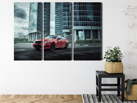 Obraz Wieloczęściowy Czerwony Samochód Na Tle Nowoczesnych Drapaczy Chmur Obraz Wieloczęściowy Czerwony Samochód Na Tle Nowoczesnych Drapaczy Chmur