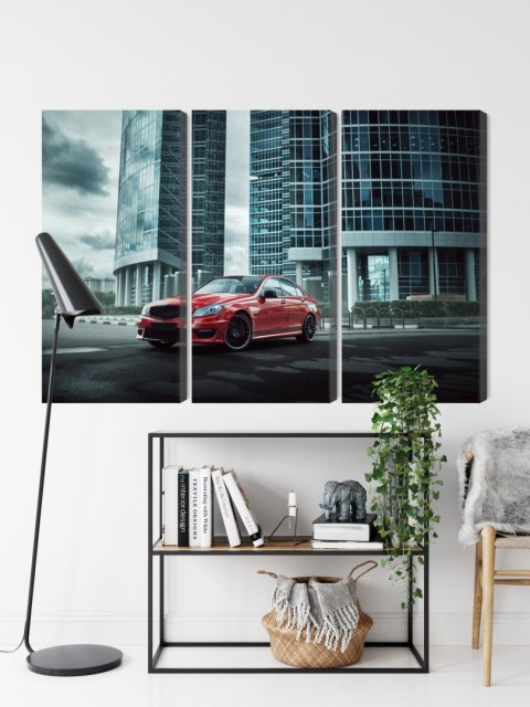 Obraz Wieloczęściowy Czerwony Samochód Na Tle Nowoczesnych Drapaczy Chmur Obraz Wieloczęściowy Czerwony Samochód Na Tle Nowoczesnych Drapaczy Chmur